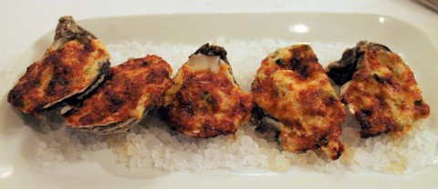 Grilled oysters with a lot of cheese.