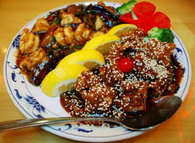 Shrimp, scallops, and eggplant with black bean sauce (left) and sesame chicken (right) at Sesame Inn.