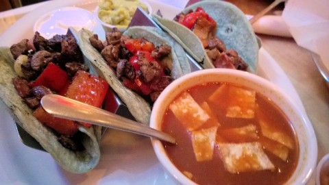 Tacos Norteños, with tortilla and chicken soup in the foreground.